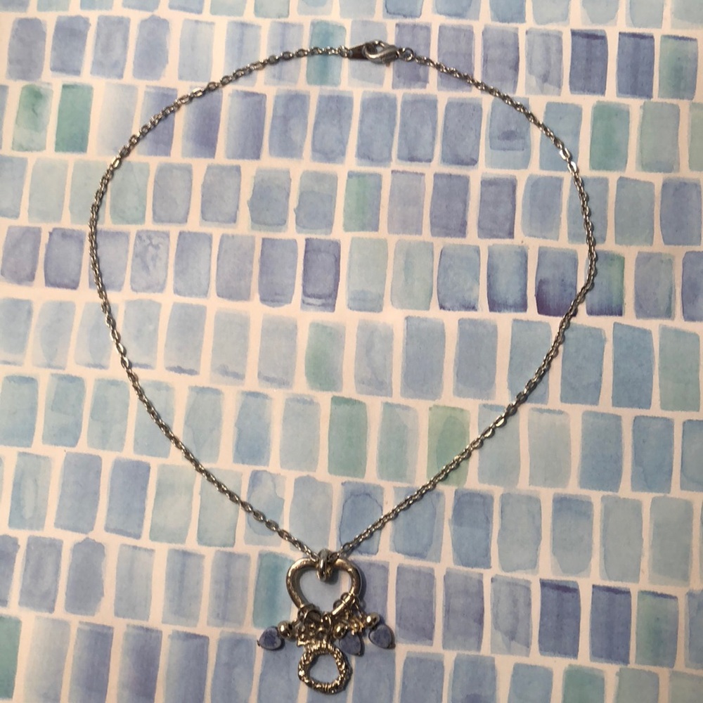 Silver necklace with heart pendant.
